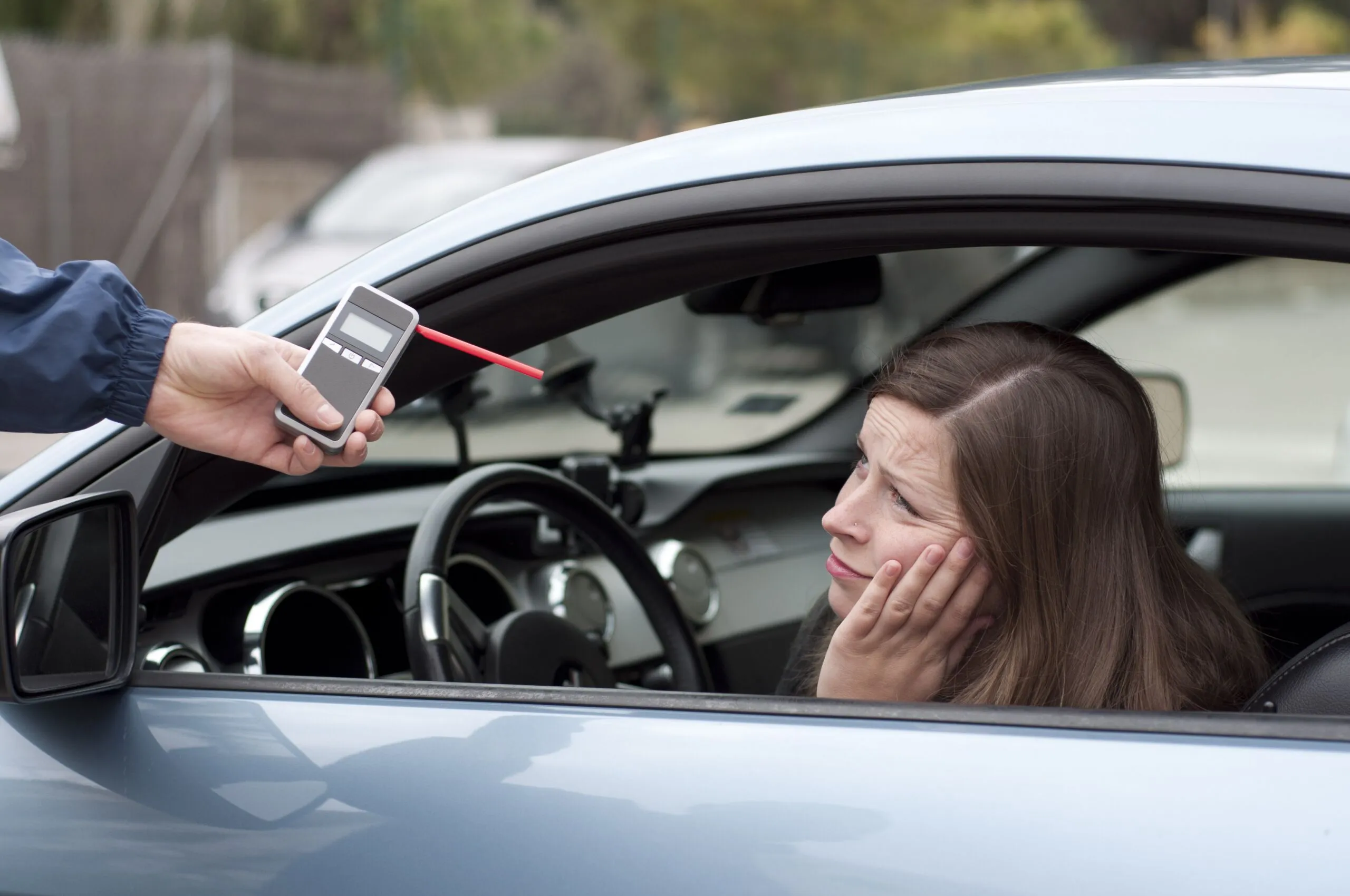DWI arrest with police officer conducting roadside sobriety test.