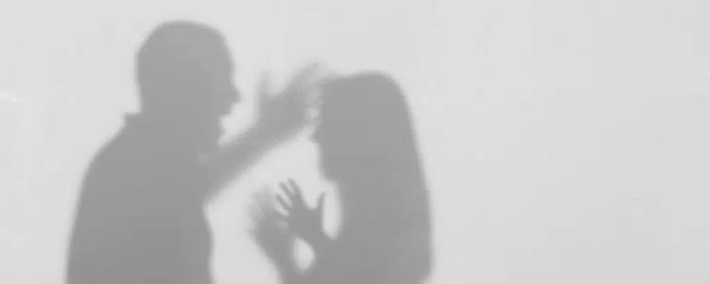Shadow of a man and woman in a conflict, representing an assault on a female charge dismissed.