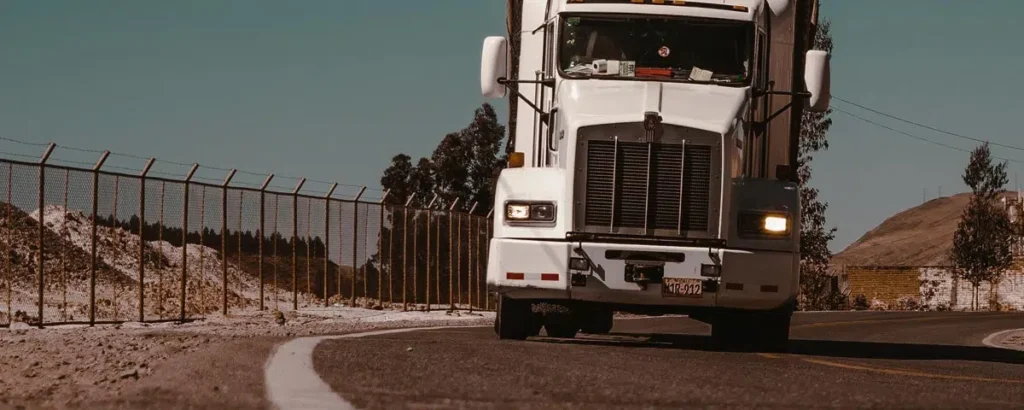 Semi-truck driving on a highway, illustrating issues related to civil revocation of a CDL in North Carolina.
