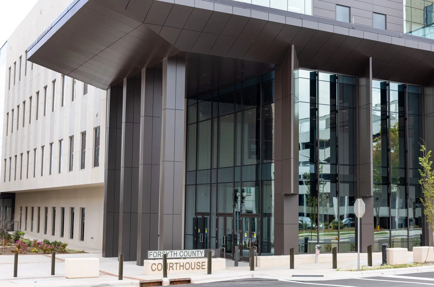 Forsyth County Courthouse features modern architecture with large glass windows and a prominent entrance sign.