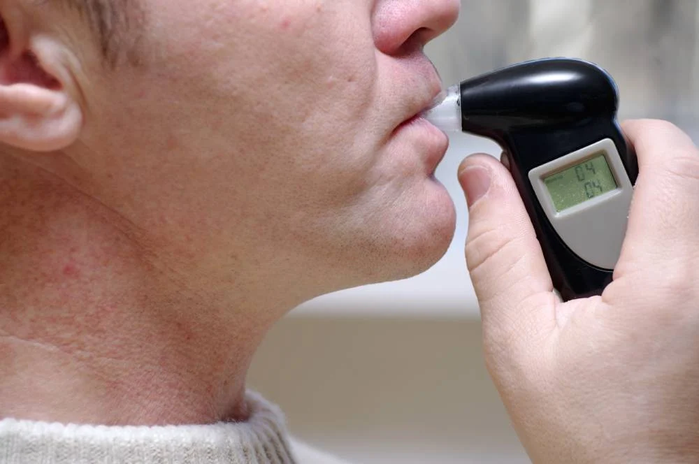 Driver taking blood test for alcohol level check.