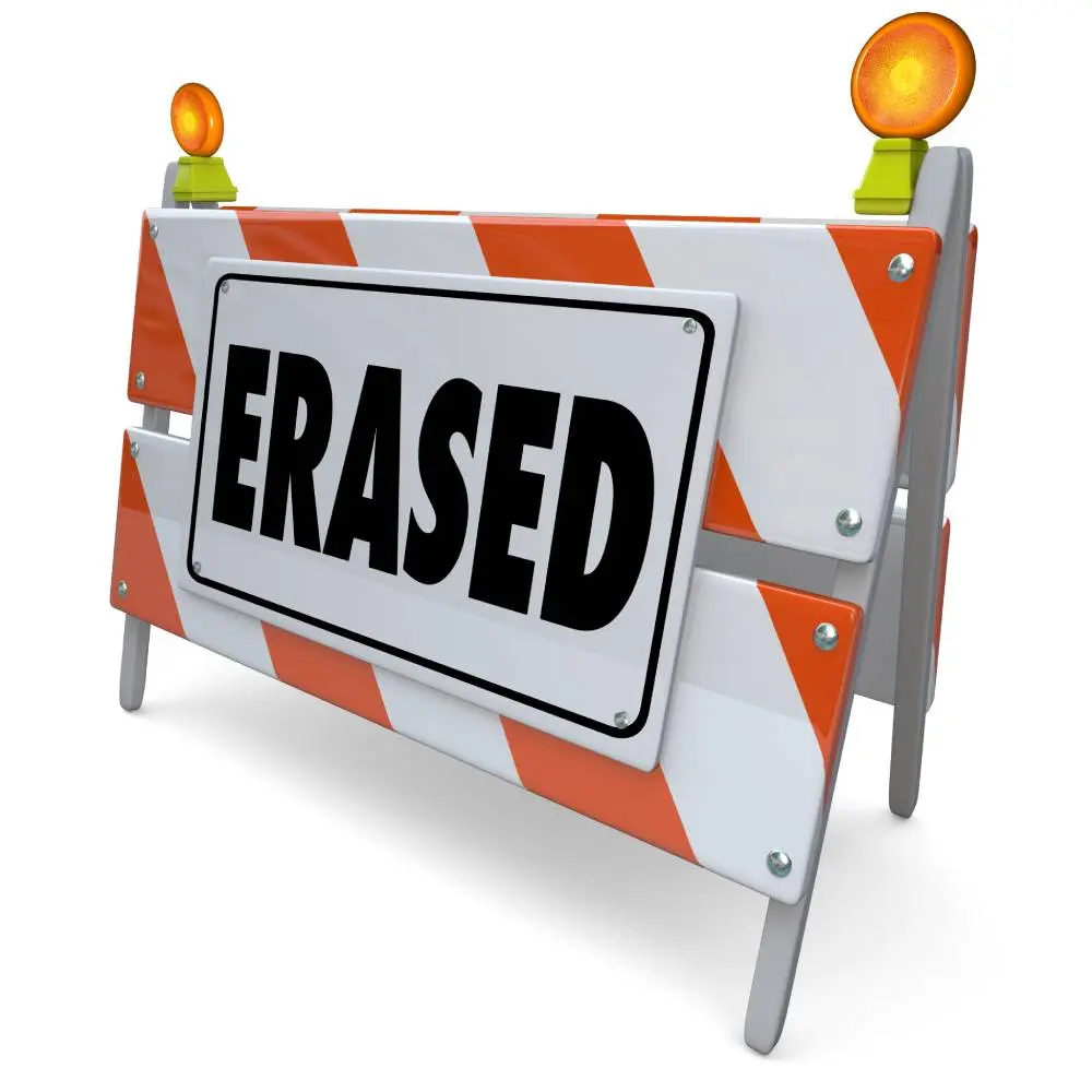Orange and white barricade with a large sign reading "ERASED" in bold black letters.