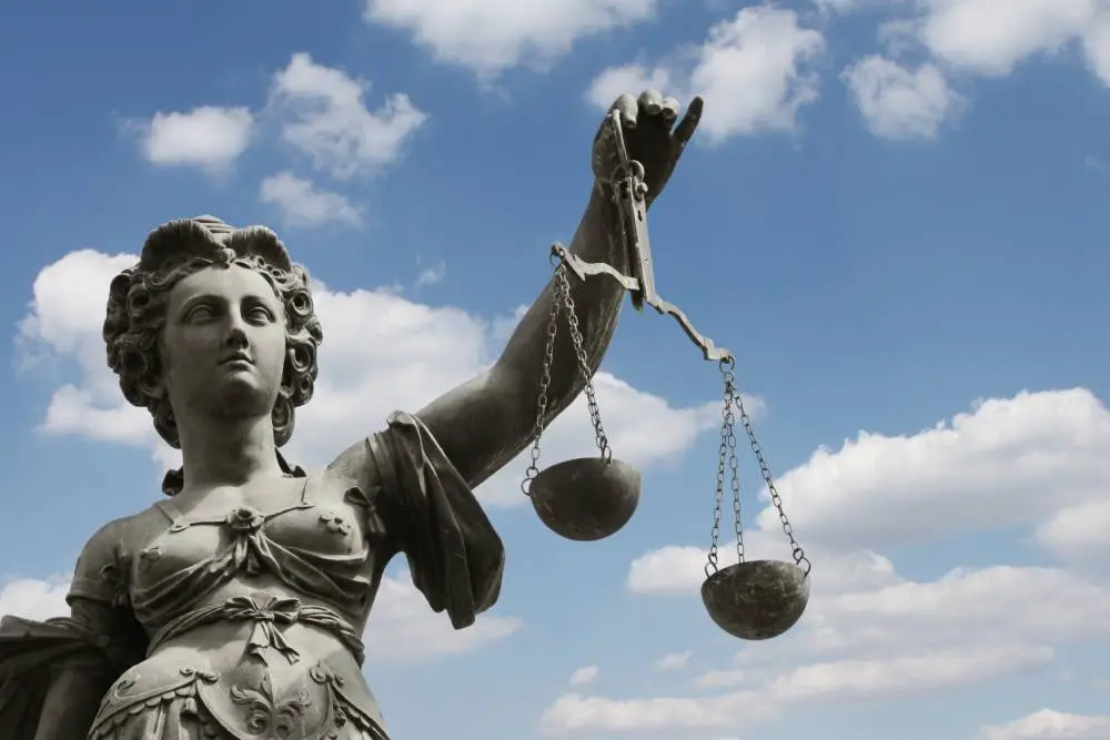 Law and justice concept with gavel, scales, and legal books on desk.