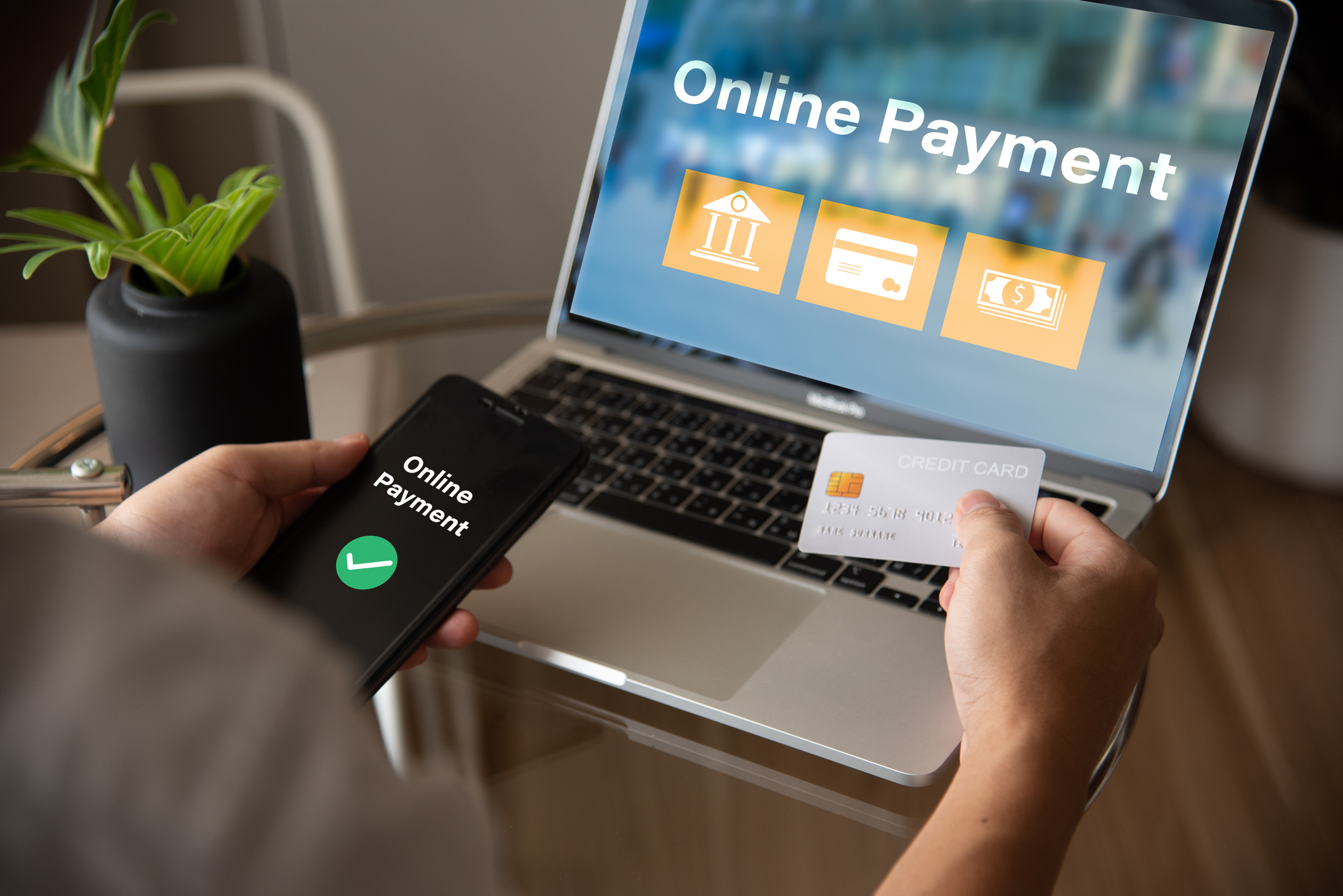 Online payment with laptop, credit card, and smartphone.