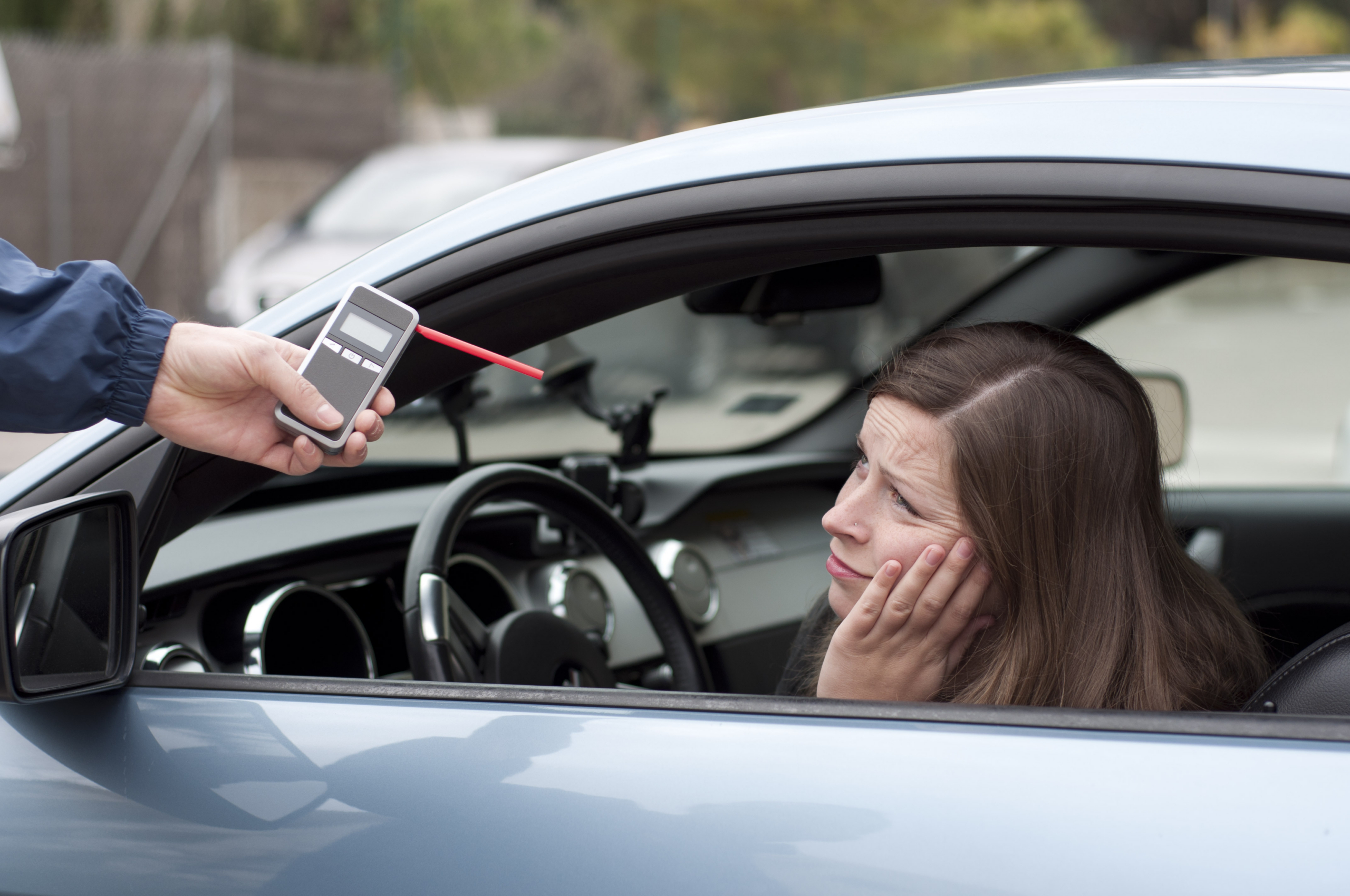 DWI arrest with police officer conducting roadside sobriety test.
